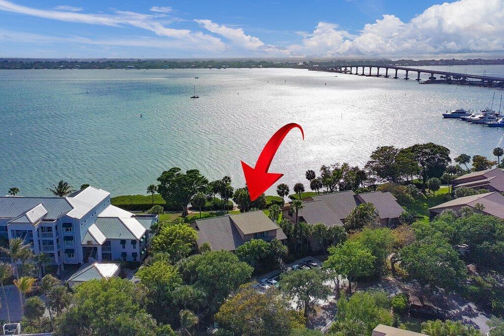 An aerial view shows a waterfront house with a red arrow pointing toward the property — 218 NE Edgewater Drive # 218, Hutchinson Island FL 34996, HUTCHINSON ISLAND, FL