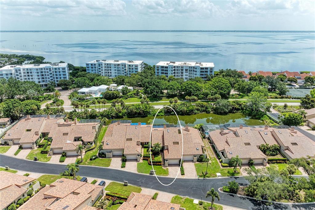 An aerial view shows a residential townhome complex with a circled unit near water — 2350 HARBOUR OAKS DRIVE, LONGBOAT KEY, FL