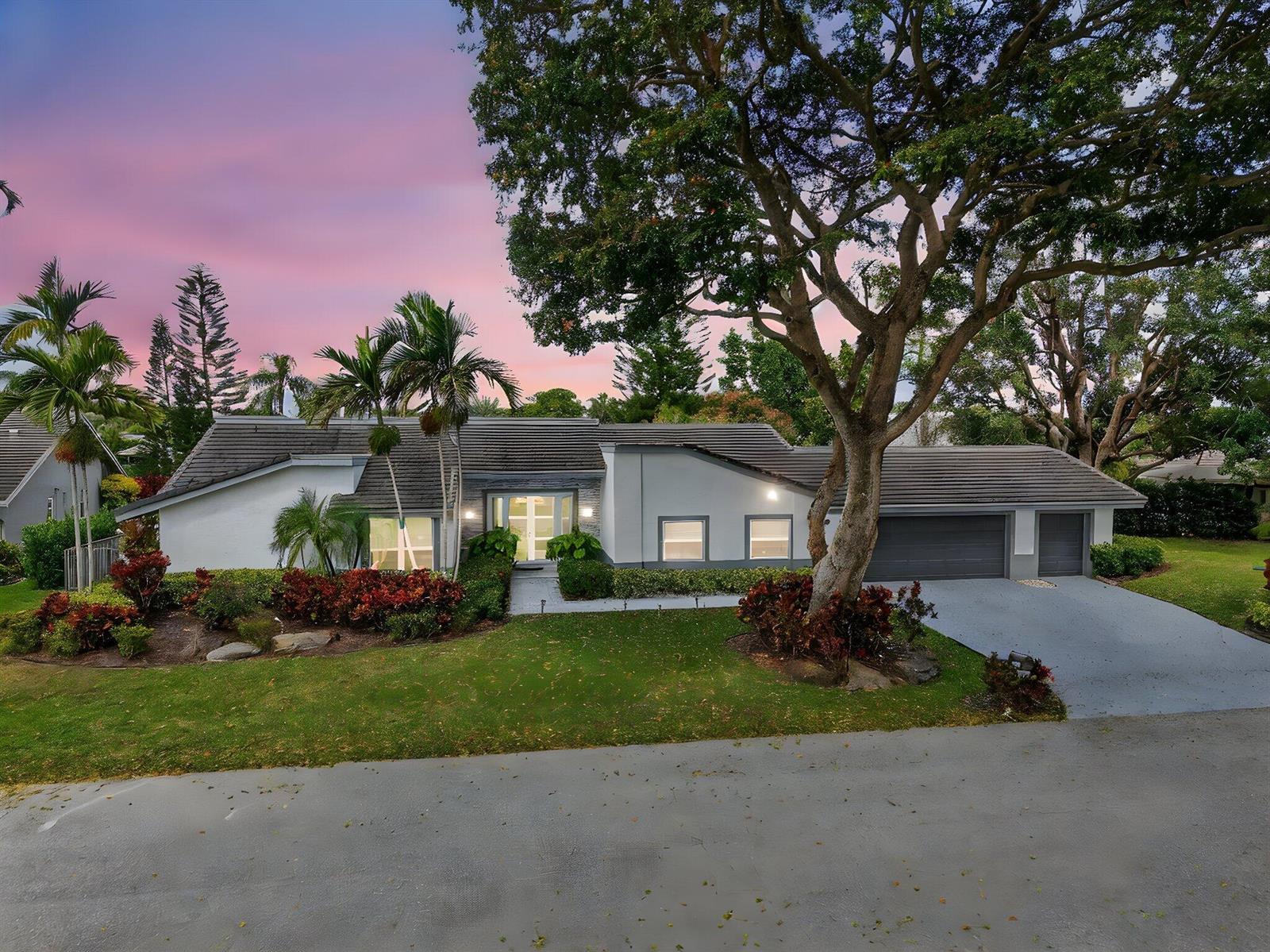 A single-story house with a gray tile roof, a large tree, and a paved driveway — 4869 Pineview Circle, Delray Beach FL 33445, DELRAY BEACH, FL