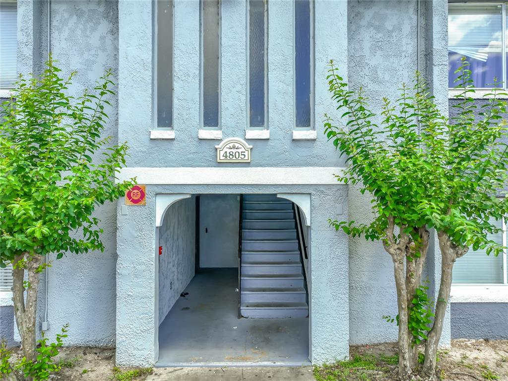 An exterior view of a building entrance with a staircase and a fire department sign — 4805 S TEXAS AVENUE UNIT 4805A, ORLANDO, FL