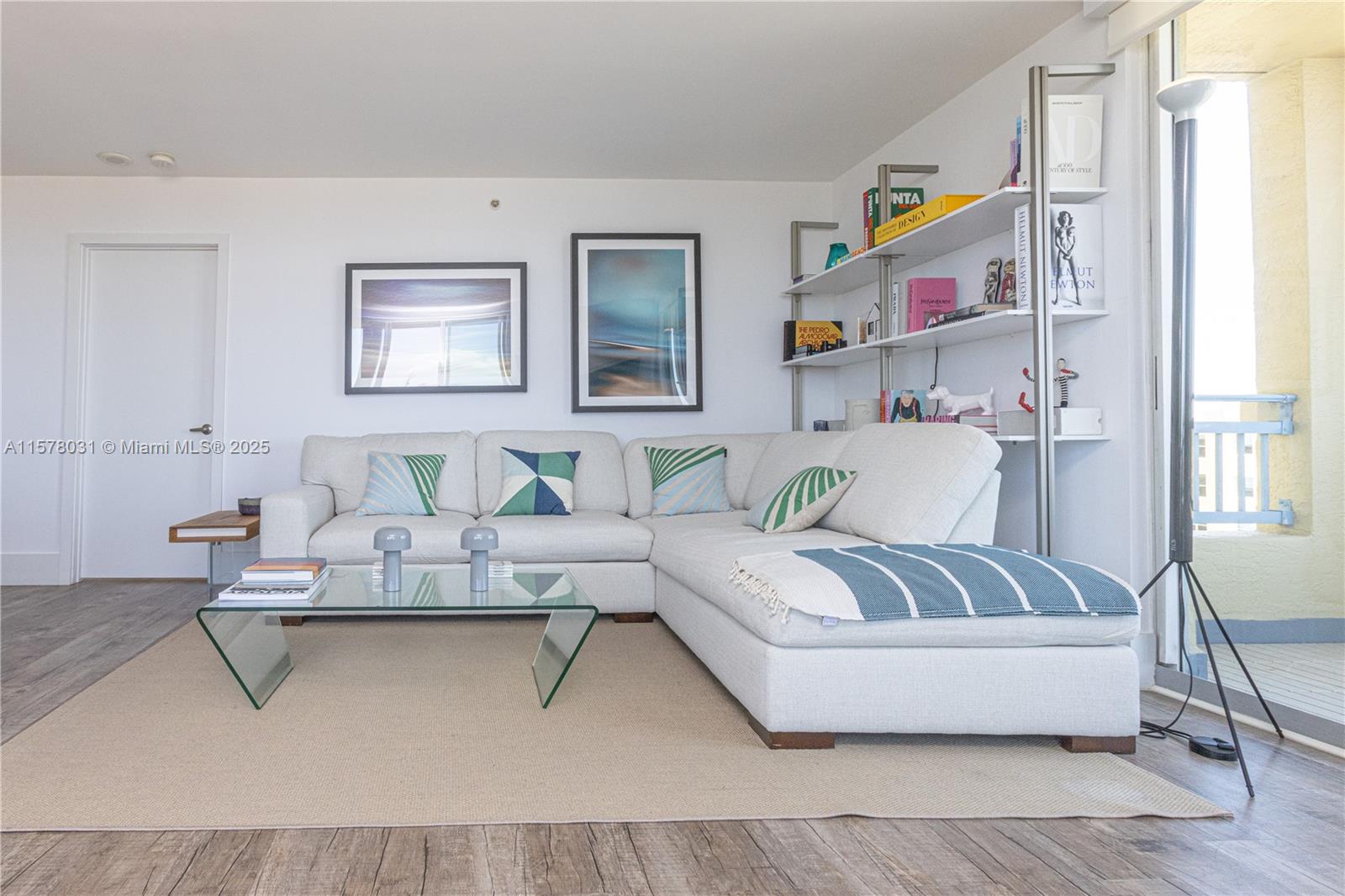 A living room features a white sectional sofa, a glass coffee table, and open shelving — 90 Alton Rd # 1411, Miami Beach FL 33139, MIAMI BEACH, FL
