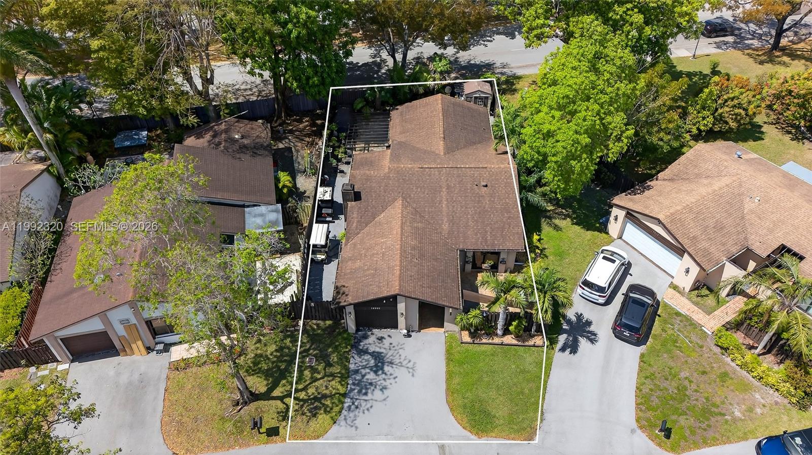 An aerial view shows a single-story house with a brown roof and a paved driveway — 10861 SW 132nd Cir Ct, Miami FL 33186, MIAMI, FL
