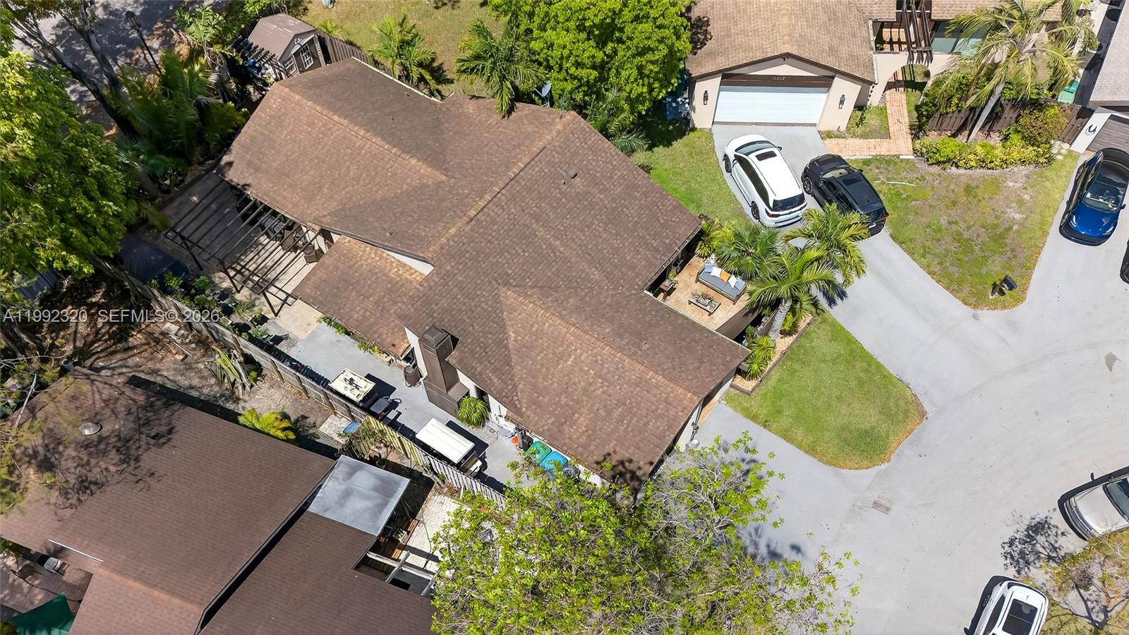 An aerial view shows a residential house with a brown shingled roof and driveway — 10861 SW 132nd Cir Ct, Miami FL 33186, MIAMI, FL