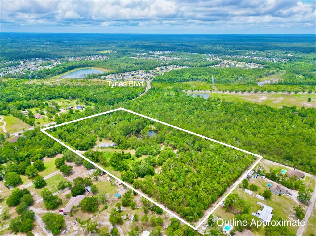An aerial view shows a large, wooded plot of land outlined in white — 3622 TRAIL RIDGE ROAD, MIDDLEBURG, FL