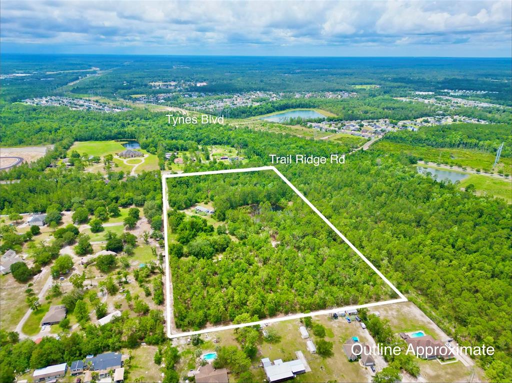 An aerial view shows a wooded plot of land outlined in white near a road — 3622 TRAIL RIDGE ROAD, MIDDLEBURG, FL