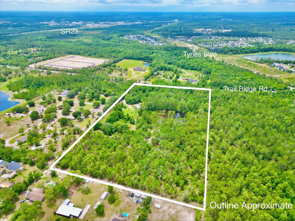 An aerial view shows a large, wooded rectangular plot of land outlined in white — 3622 TRAIL RIDGE ROAD, MIDDLEBURG, FL