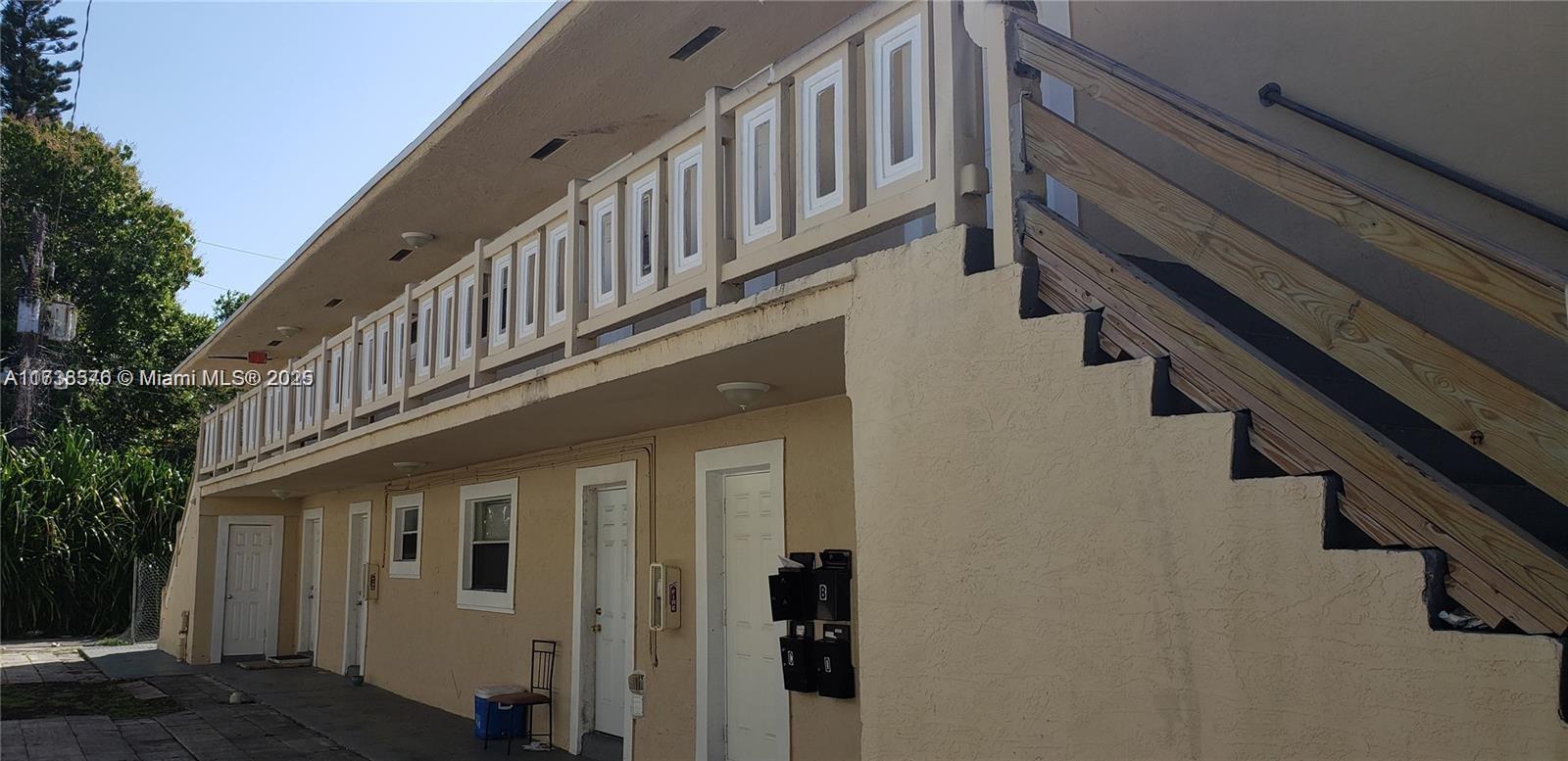 An exterior view of a two-story apartment building with a wooden staircase and balcony — 624 SW 16th Ave # C, Fort Lauderdale FL 33312, FORT LAUDERDALE, FL
