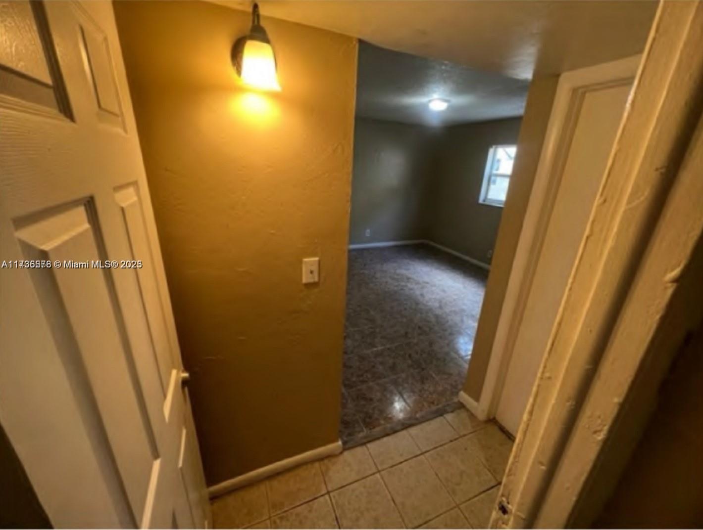 A doorway leads from a tiled entryway into a room with brown walls and flooring — 624 SW 16th Ave # C, Fort Lauderdale FL 33312, FORT LAUDERDALE, FL
