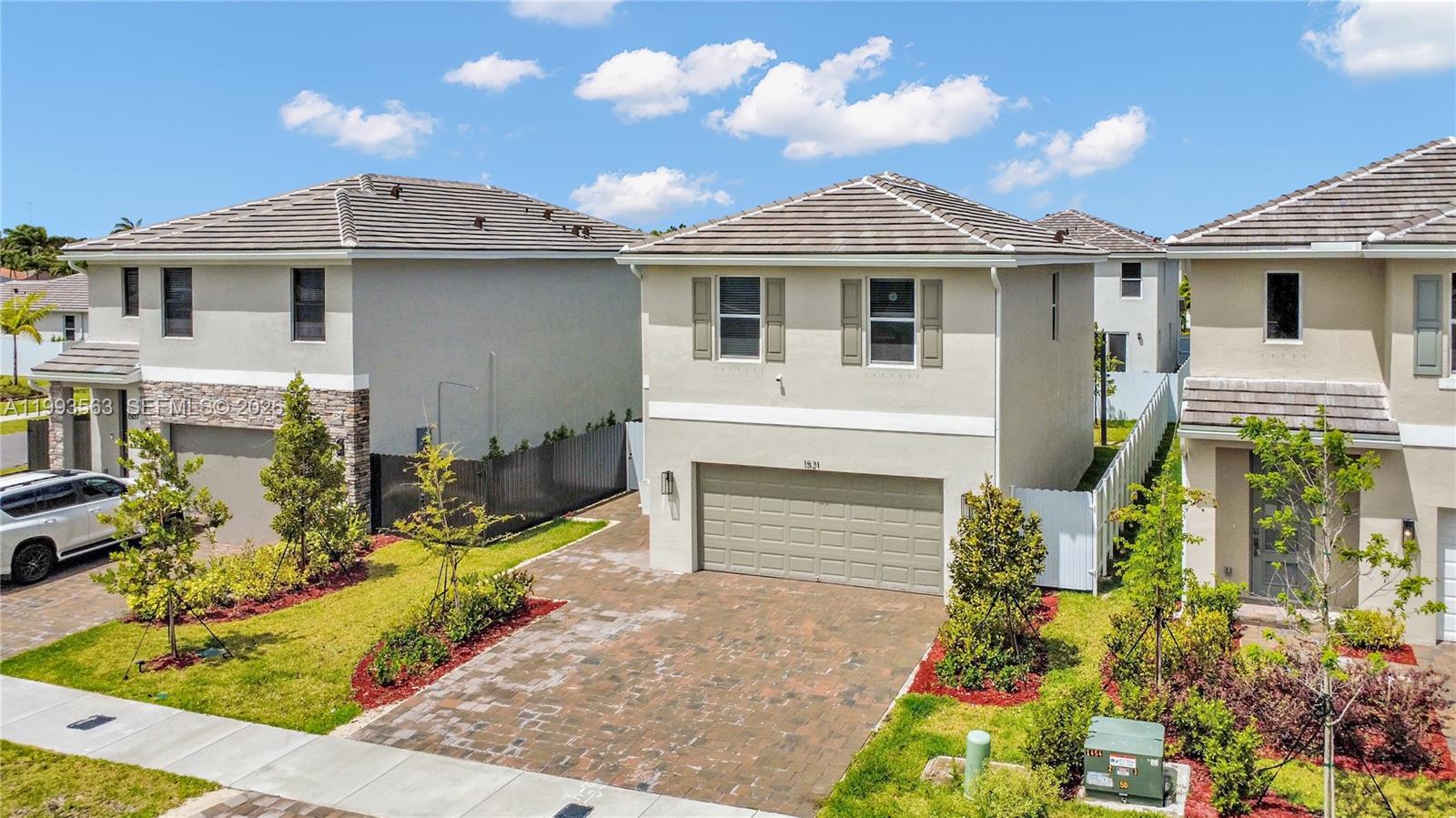 An aerial view shows a two-story suburban house with a paved driveway and garage — 1521 SE 7th Ct, Homestead FL 33033, HOMESTEAD, FL