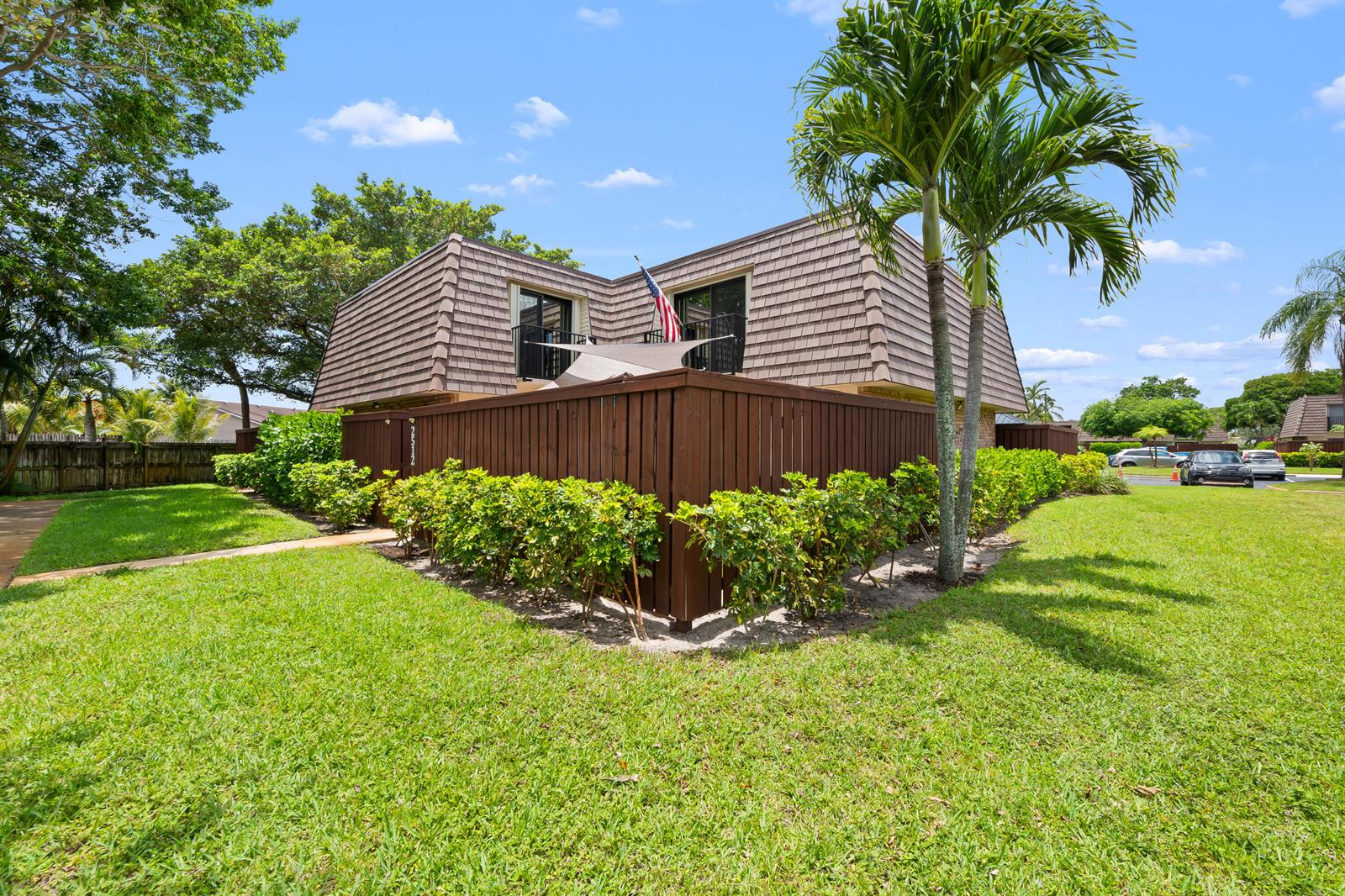 A two-story building with a brown mansard roof and a wooden privacy fence — 2512 SW 15th Street, Deerfield Beach FL 33442, DEERFIELD BEACH, FL