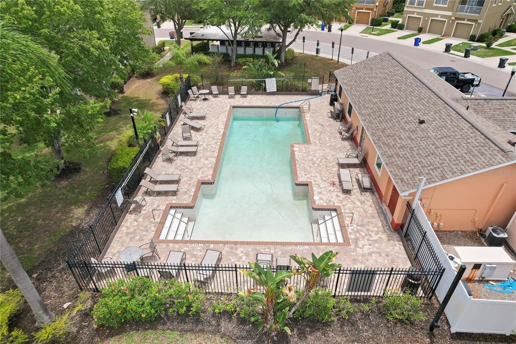 An aerial view of a rectangular swimming pool with a paver deck and lounge chairs — 9107 MOONLIT MEADOWS LOOP, RIVERVIEW, FL