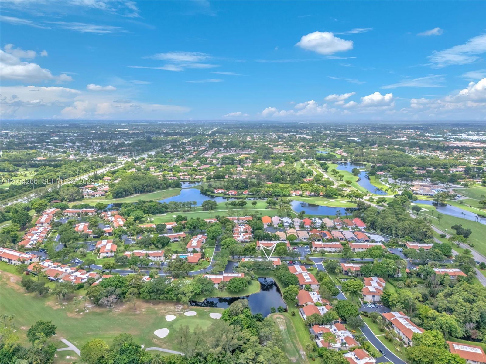 An aerial view shows a residential community with townhomes, ponds, and a golf course — 21698 Cypress Rd # 44D, Boca Raton FL 33433, BOCA RATON, FL