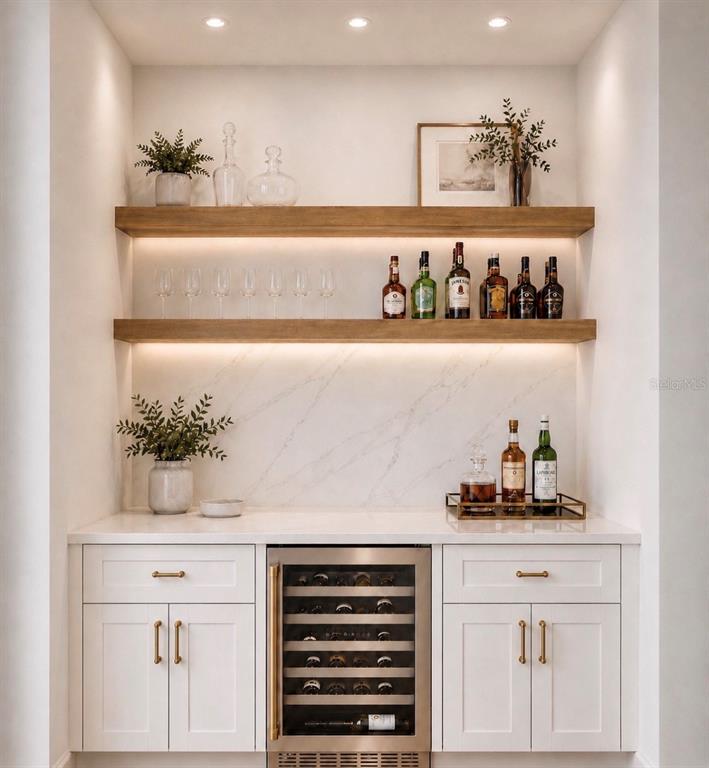 A home bar features white cabinetry, a wine cooler, marble backsplash, and two floating wood shelves — 5204 BAKER AVENUE, ORLANDO, FL