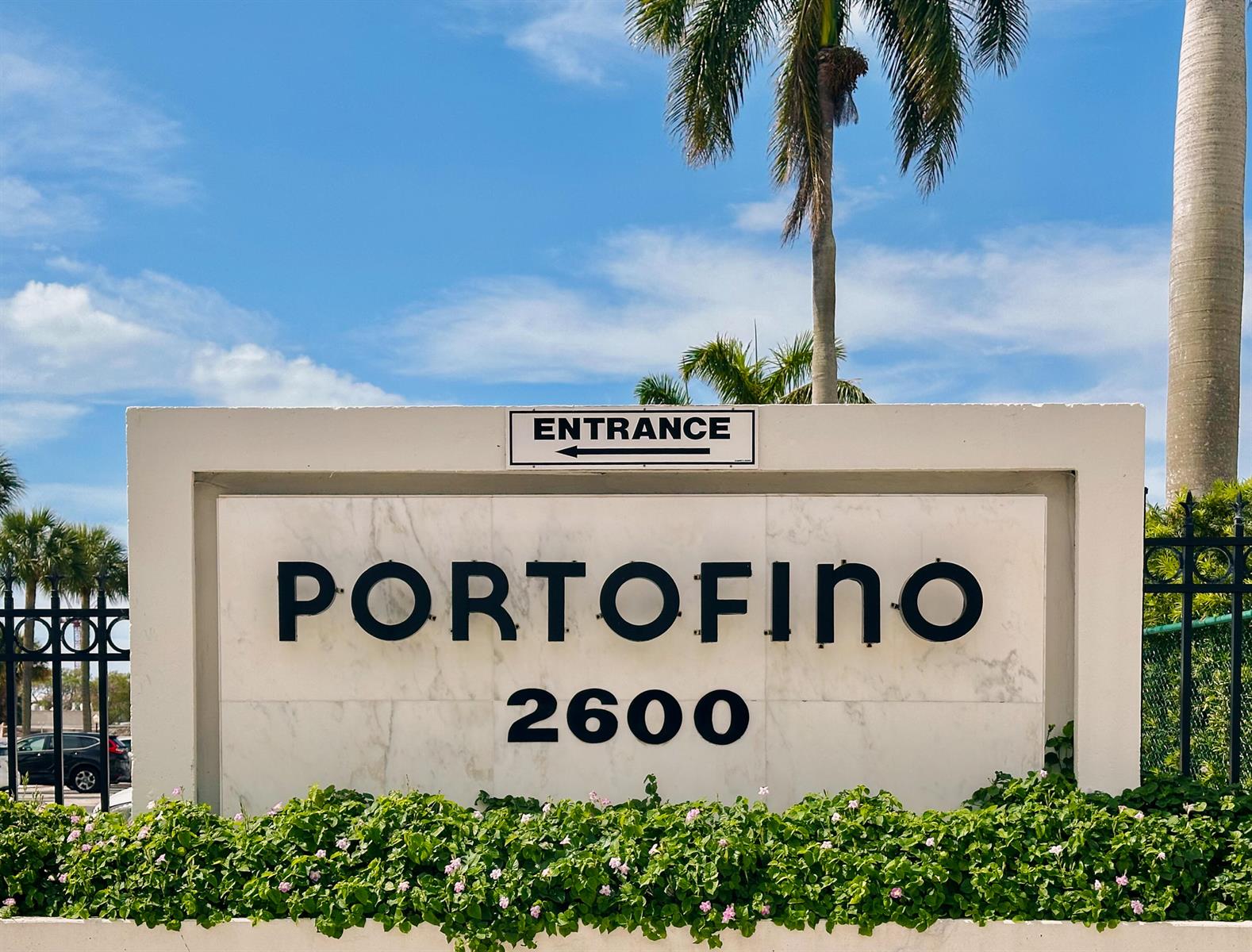 A white stone monument sign displays the name Portofino and the number 2600 — 2600 N Flagler Drive # 803, West Palm Beach FL 33407, WEST PALM BEACH, FL