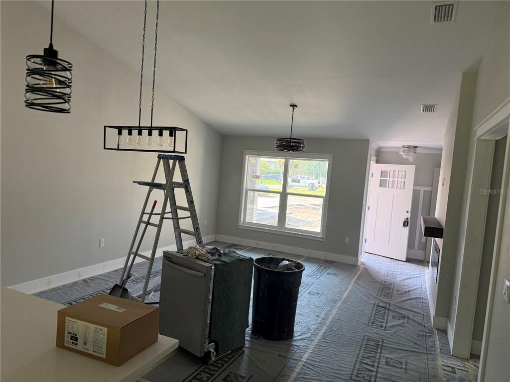 An interior view of a room under construction with a ladder, appliances, and light fixtures — 62 EMERSON DRIVE, PALM COAST, FL