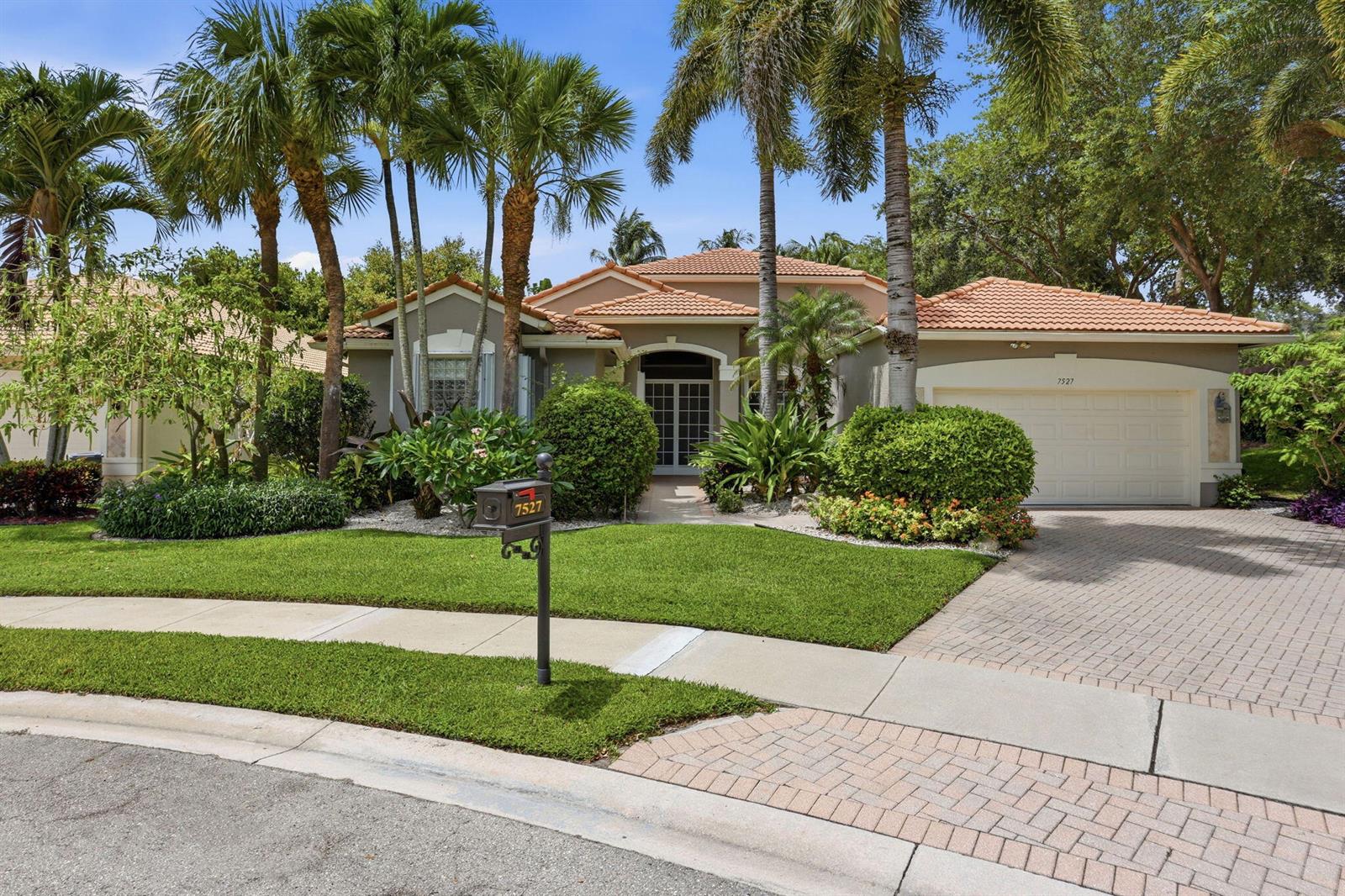 A single-story house with a tile roof, palm trees, and a brick paver driveway — 7527 Monticello Way, Boynton Beach FL 33437, BOYNTON BEACH, FL