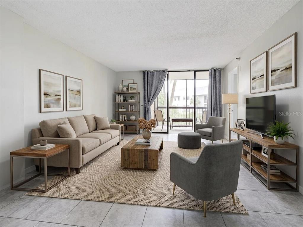 A living room features a beige sofa, two grey armchairs, a wooden coffee table, and tile flooring — 3006 CARING WAY UNIT 210, PORT CHARLOTTE, FL