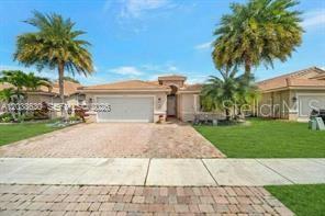 A single-story house with a brick driveway, a two-car garage, and palm trees — 1531 SW 194TH TERRACE, PEMBROKE PINES, FL