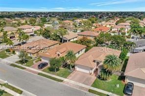 An aerial view shows a suburban neighborhood with several single-family homes and paved streets — 1531 SW 194TH TERRACE, PEMBROKE PINES, FL