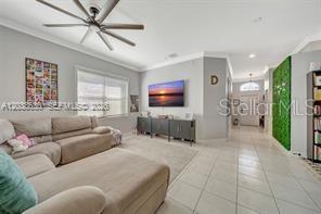 A living room features a large sectional sofa, a wall-mounted television, and a ceiling fan — 1531 SW 194TH TERRACE, PEMBROKE PINES, FL