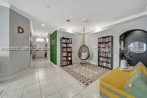 A room features a hanging chair, two bookshelves, a patterned rug, and a yellow sofa — 1531 SW 194TH TERRACE, PEMBROKE PINES, FL