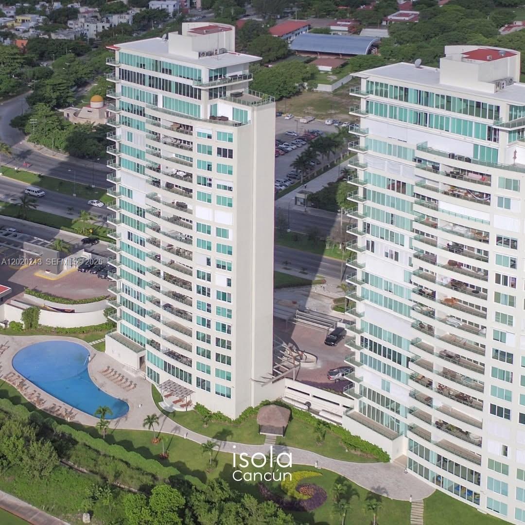 An aerial view shows two tall residential towers with balconies and a swimming pool below — Av Bonampak sm 3-01 # 305, Ca, Ca