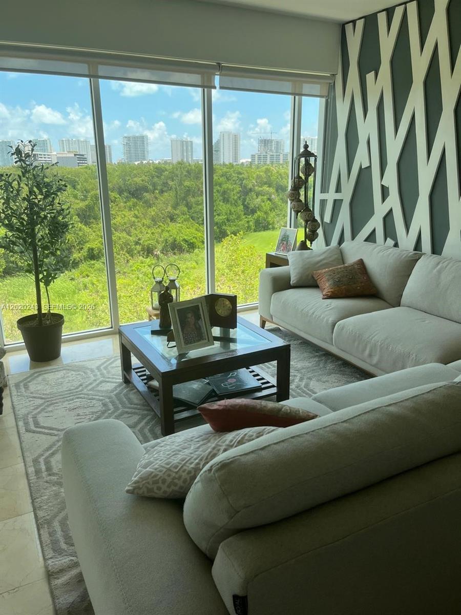 A living room features two light-colored sofas, a glass coffee table, and floor-to-ceiling windows — Av Bonampak sm 3-01 # 305, Ca, Ca