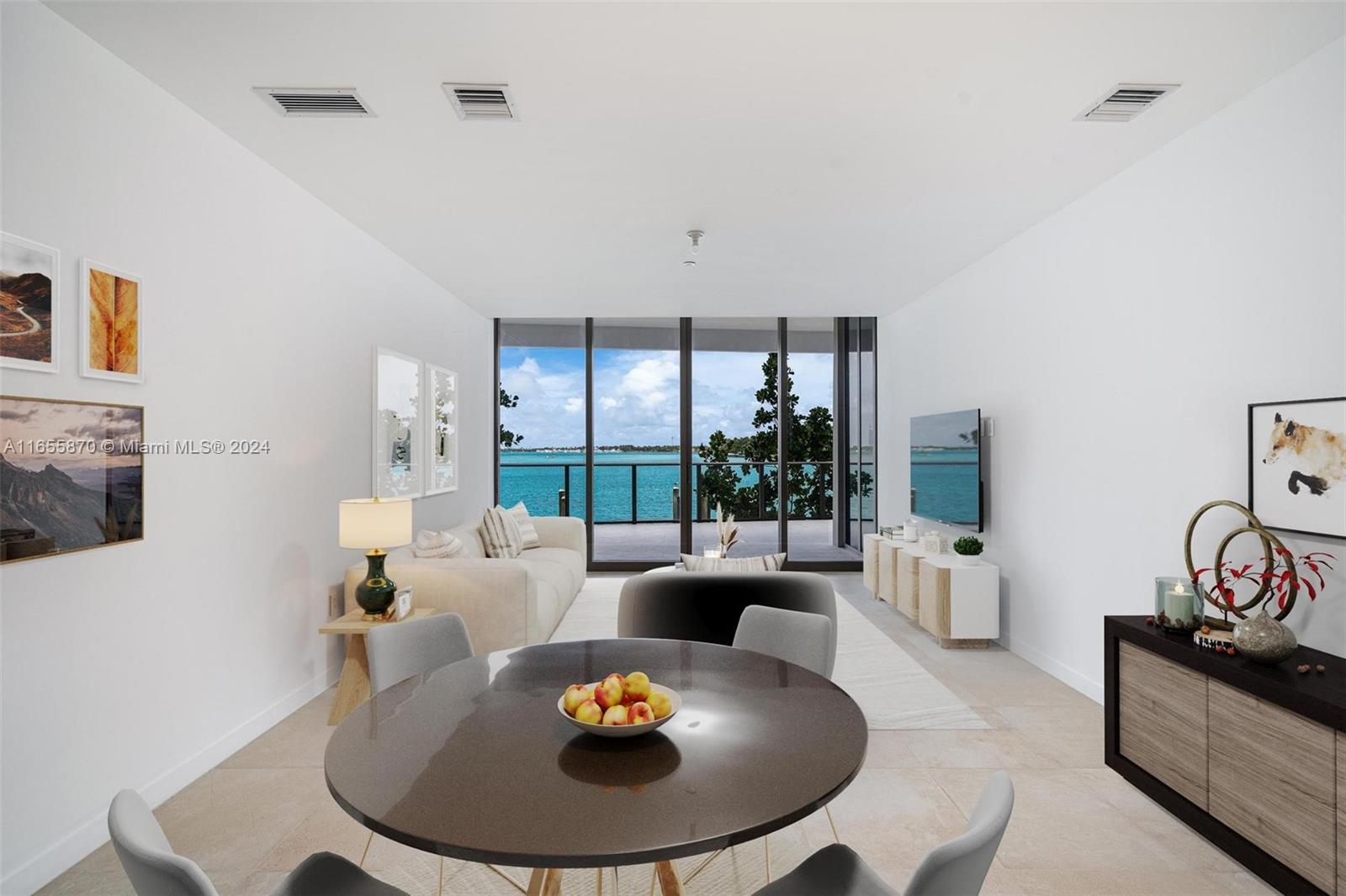 A modern living and dining room features a round table, sofa, and floor-to-ceiling balcony windows — 1135 103 St # 202, Bay Harbor Islands FL 33154, BAY HARBOR ISLANDS, FL