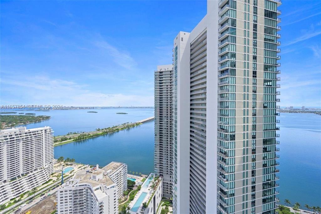 An aerial view shows high-rise residential towers overlooking a bay and a causeway — 501 NE 31st Street # 3804, Miami FL 33137, MIAMI, FL