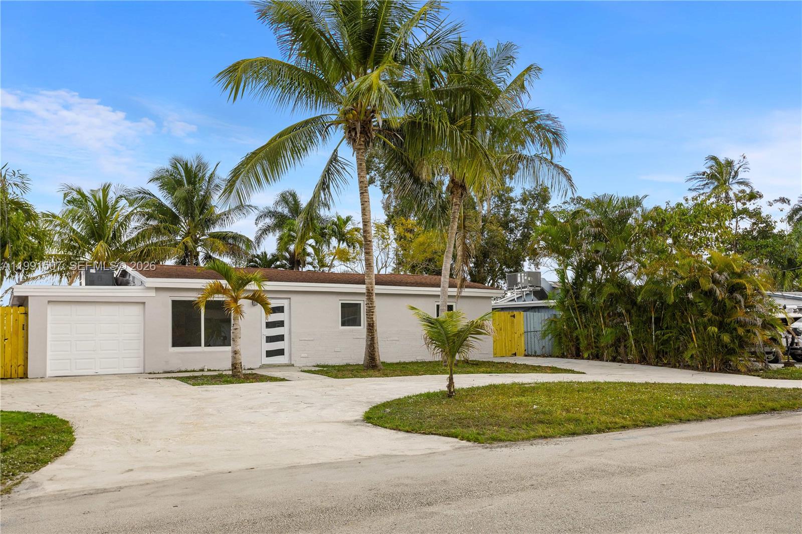 A single-story house with a white garage door and palm trees in the front yard — 4157 SW 49th Ct, Dania Beach FL 33314, DANIA BEACH, FL