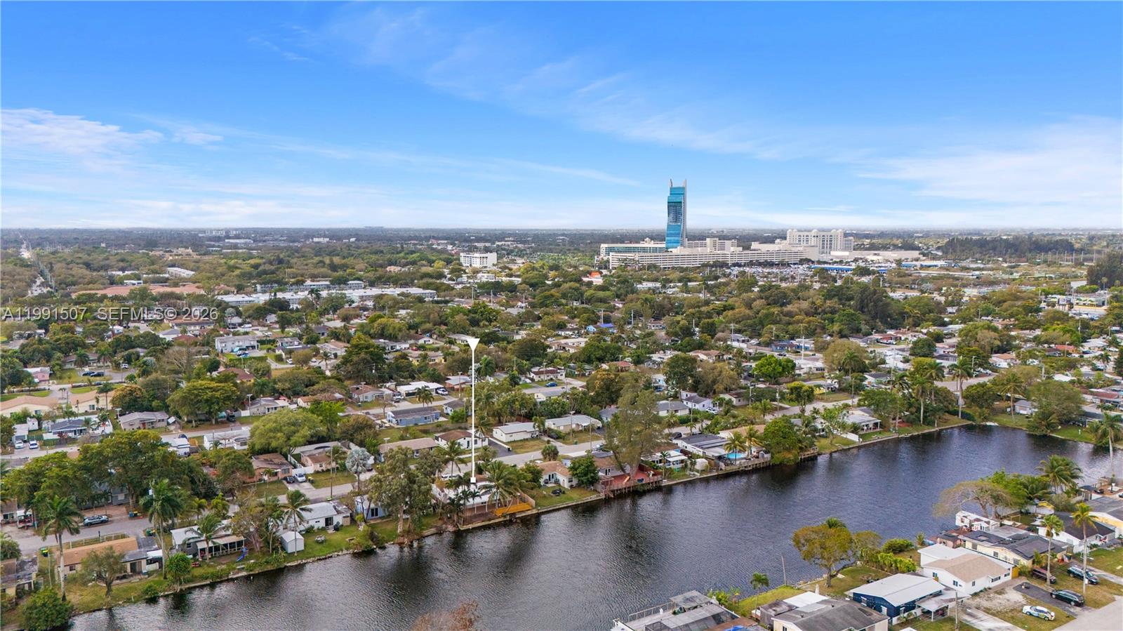 An aerial view shows a residential neighborhood with a canal and a marked house — 4157 SW 49th Ct, Dania Beach FL 33314, DANIA BEACH, FL