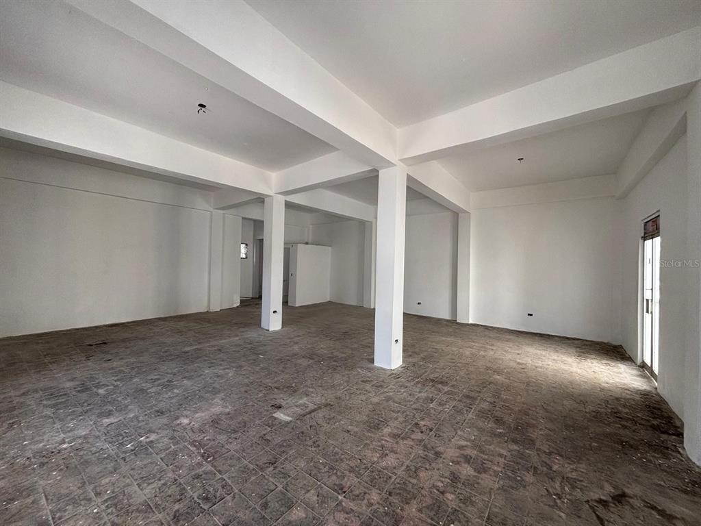 An empty, unfinished commercial space features white walls, exposed ceiling beams, and tiled flooring — 16 CELIS AGUILERA ST. CORNER, MANATI, PR