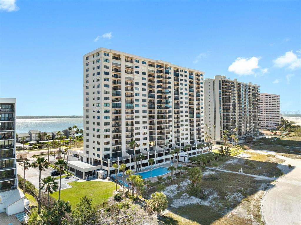 An aerial view of two tall residential buildings near a beach and a swimming pool — 1270 GULF BOULEVARD UNIT 606, CLEARWATER BEACH, FL