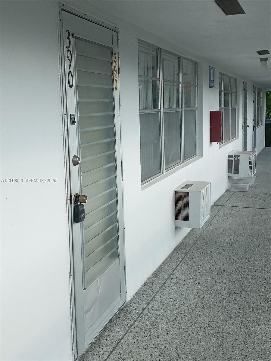 An exterior walkway features a white door labeled 390 and two wall-mounted air conditioning units — 390 Windsor Q # 390, West Palm Beach FL 33417, WEST PALM BEACH, FL