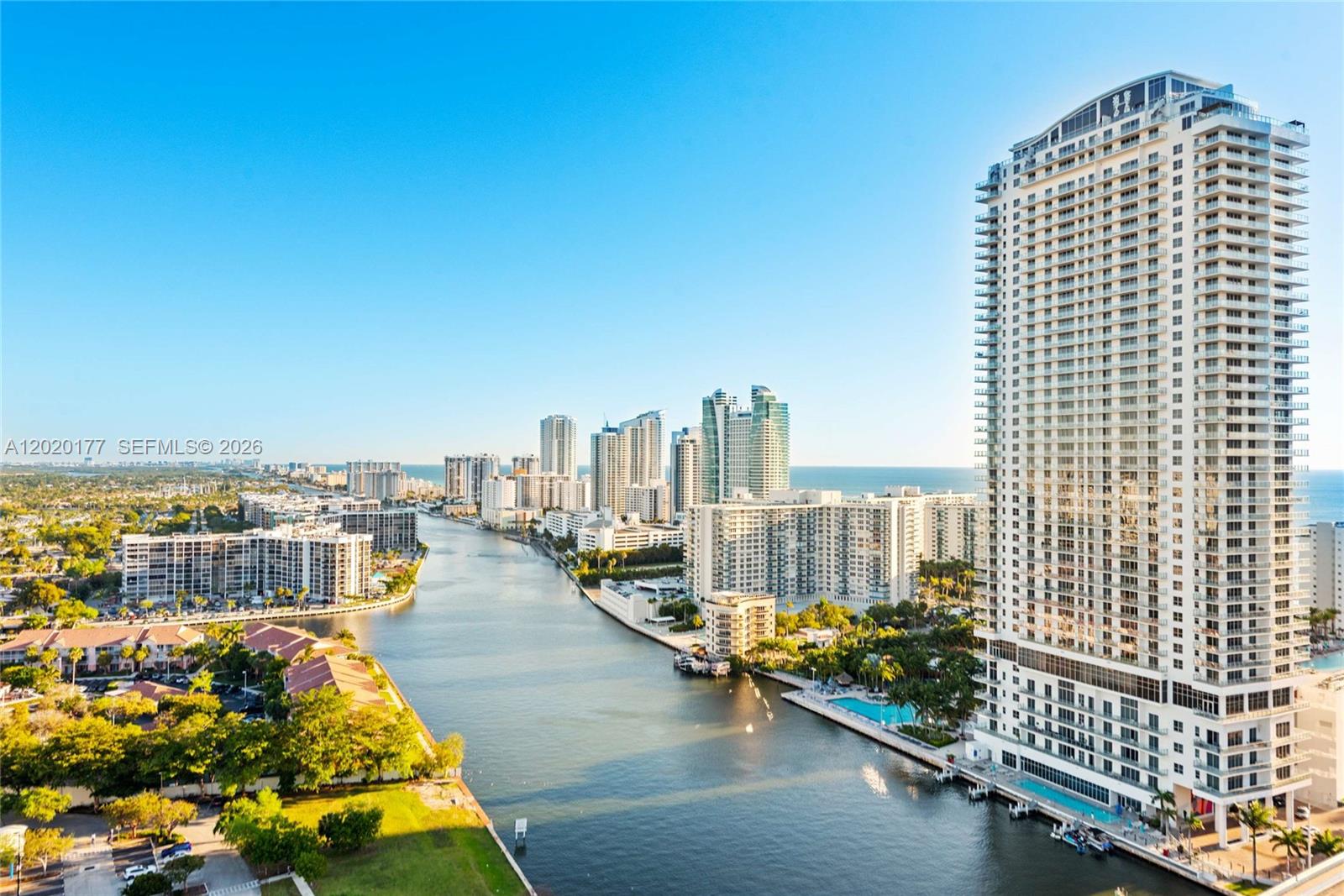 An aerial view shows a waterway flanked by high-rise residential buildings and coastal vegetation — 2602 E Hallandale Beach Blvd # R2604, Hallandale Beach FL 33009, HALLANDALE BEACH, FL