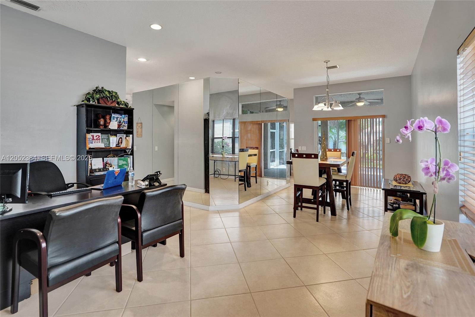 A room features a home office area, a dining set, and a mirrored wall partition — 4219 Sabal Ridge Cir, Weston FL 33331, WESTON, FL