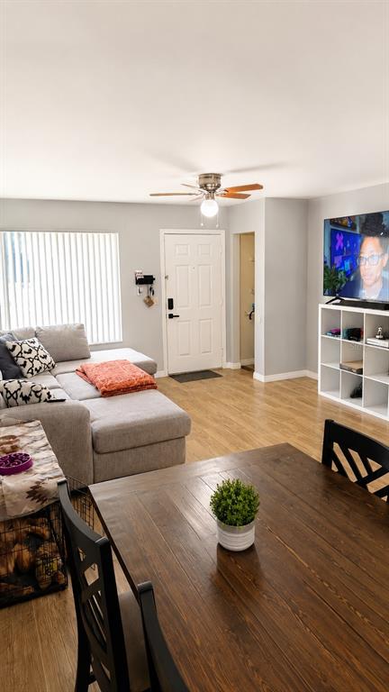 A living room features a gray sectional sofa, a dining table, and a television unit — 245 WINTER RIDGE BOULEVARD, WINTER HAVEN, FL