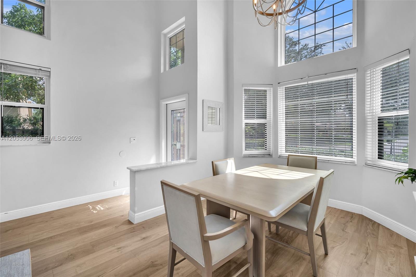 A dining area features a light wood table, four chairs, and large windows with blinds — 1651 NW 104th Ave, Plantation FL 33322, PLANTATION, FL