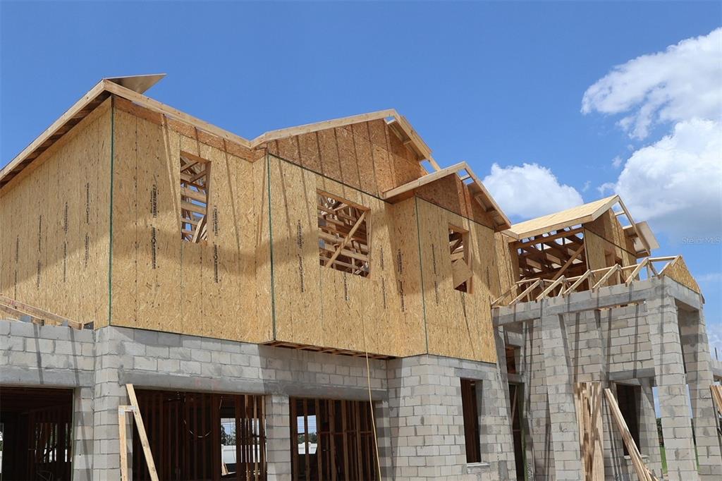 A two-story house under construction with concrete block walls and wood-framed upper levels — 17043 OVERSTORY ROAD, ORLANDO, FL