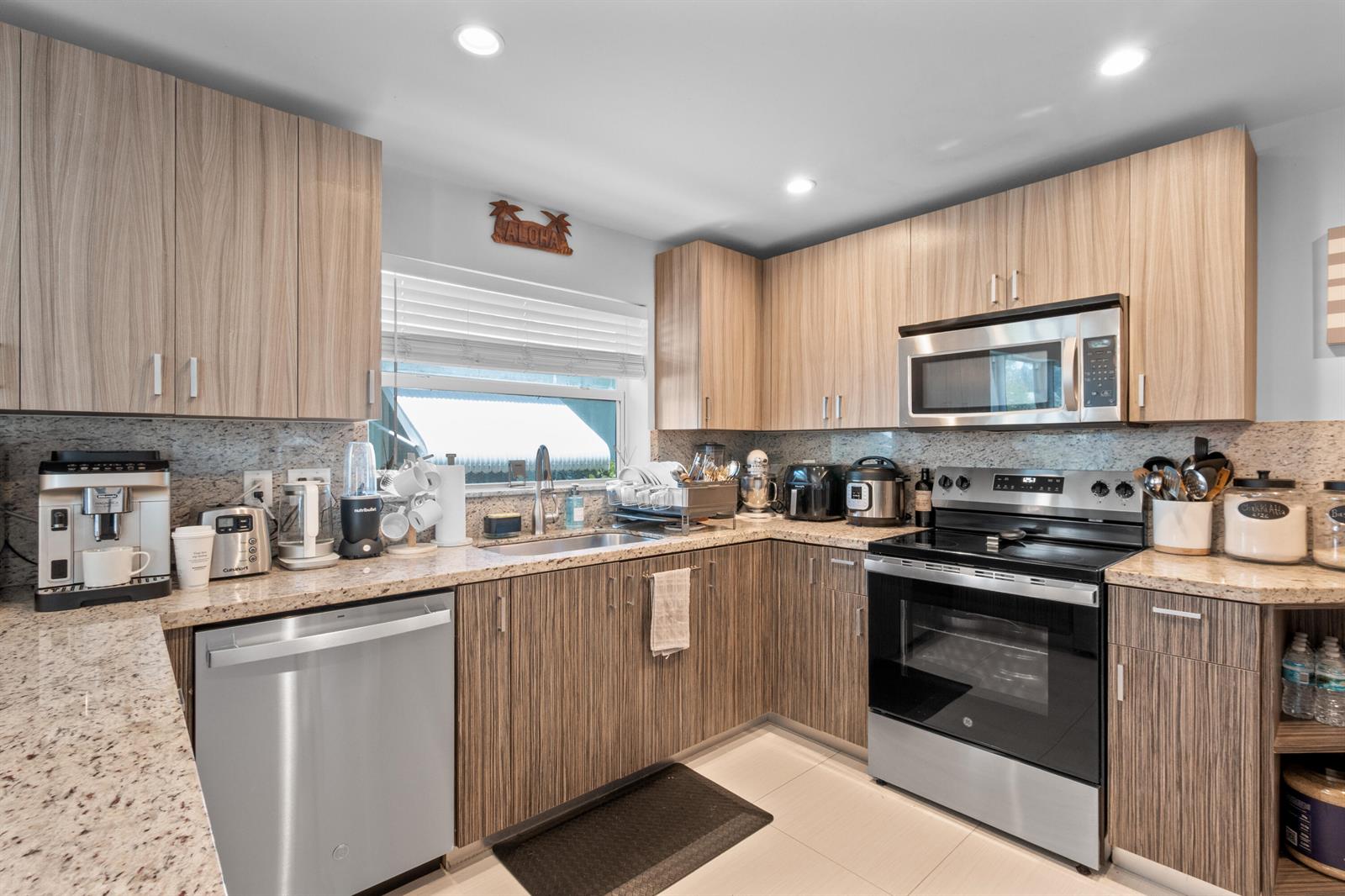 A patio features a dining set, a grill, and a hammock under palm trees — 1603 Jefferson Street, Hollywood FL 33020, HOLLYWOOD, FL