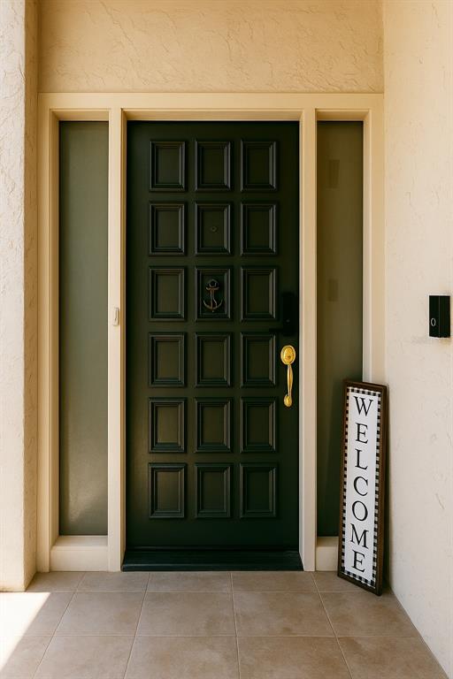 A dark green paneled front door with a gold handle and anchor knocker sits between sidelights — 4360 OUTRIGGER LANE, TAMPA, FL