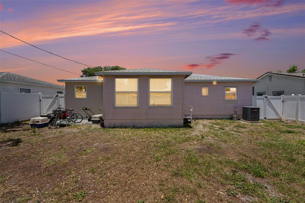A single-story house with a light-colored exterior, a concrete driveway, and a small front garden — 4540 53RD AVENUE N, ST PETERSBURG, FL