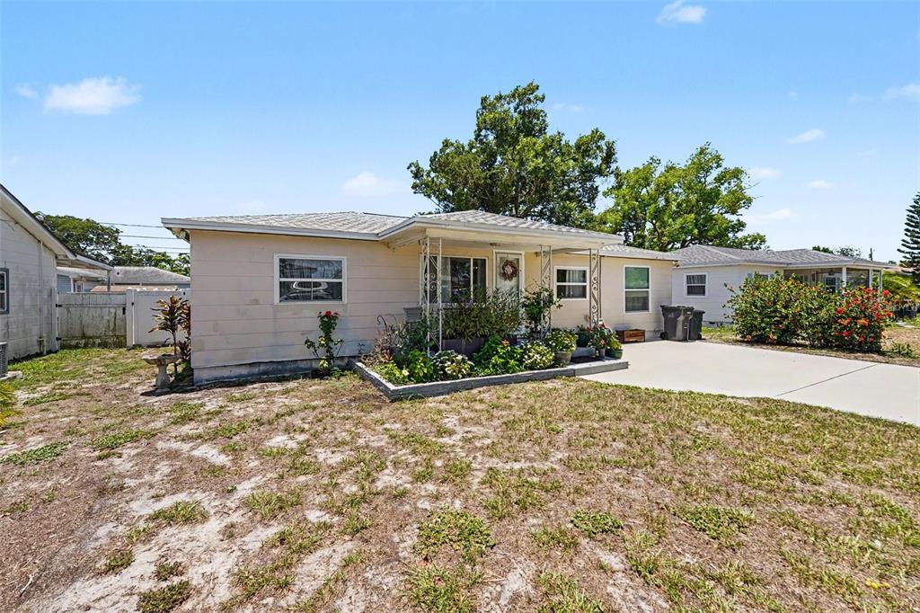 A single-story house with a concrete driveway and a front yard under a blue sky — 4540 53RD AVENUE N, ST PETERSBURG, FL