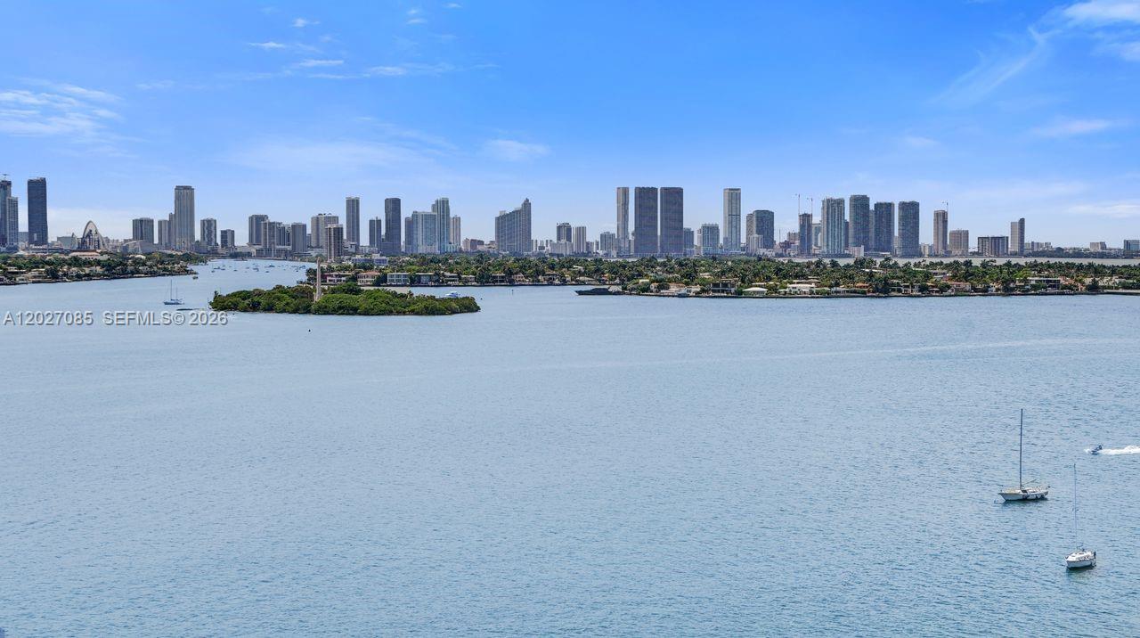 An elevated view shows a wide bay with sailboats and a distant city skyline — 1228 West Ave # 1404, Miami Beach FL 33139, MIAMI BEACH, FL