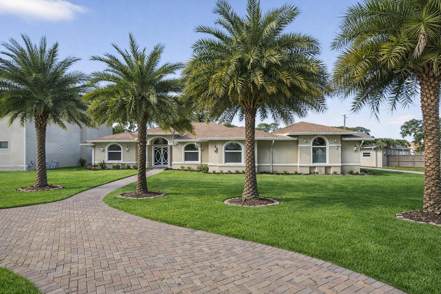 A single-story house with a paved walkway and palm trees in the front yard — 12038 Key Lime Boulevard, FL 33412, FL