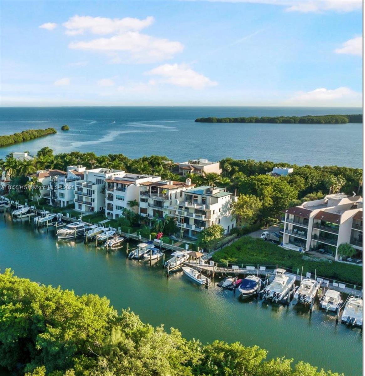 An aerial view shows waterfront townhomes with private boat slips along a canal near mangroves — 6200 SW 152nd St #5, Palmetto Bay FL 33157, PALMETTO BAY, FL