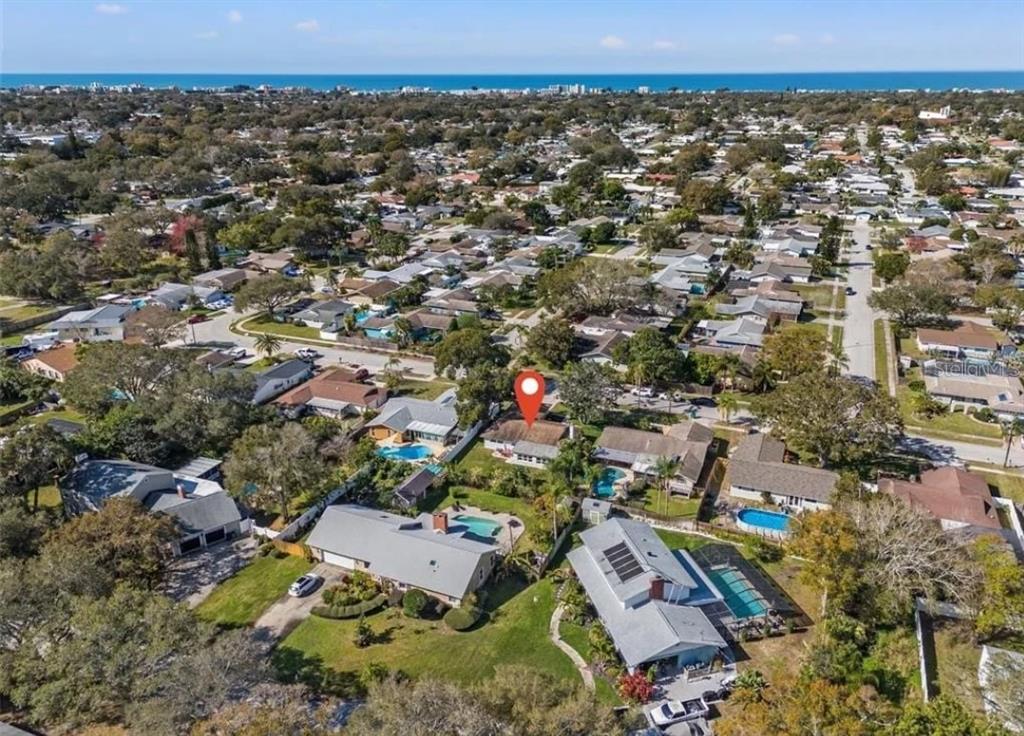 An aerial view of a residential neighborhood featuring houses with swimming pools and mature trees — 11145 BELLA LOMA DRIVE, LARGO, FL