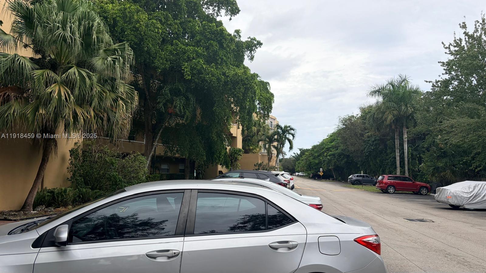 A silver sedan is parked in a lot next to a multi-story apartment building — 4111 Stirling Rd # 102, Dania Beach FL 33314, DANIA BEACH, FL
