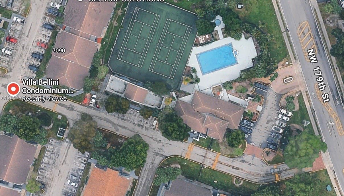 This aerial view shows a condominium complex with tennis courts, a swimming pool, and parking — 7200 NW 179th St # 302, Hialeah FL 33015, HIALEAH, FL