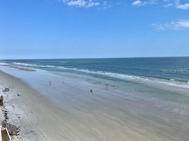 An elevated view of a sandy beach meeting the ocean under a clear blue sky — 4453 S ATLANTIC AVENUE UNIT 604, PONCE INLET, FL